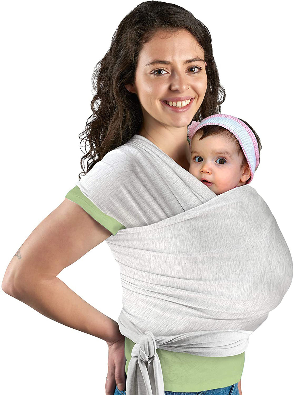 Woman holding a baby in a white wrap carrier on a white background