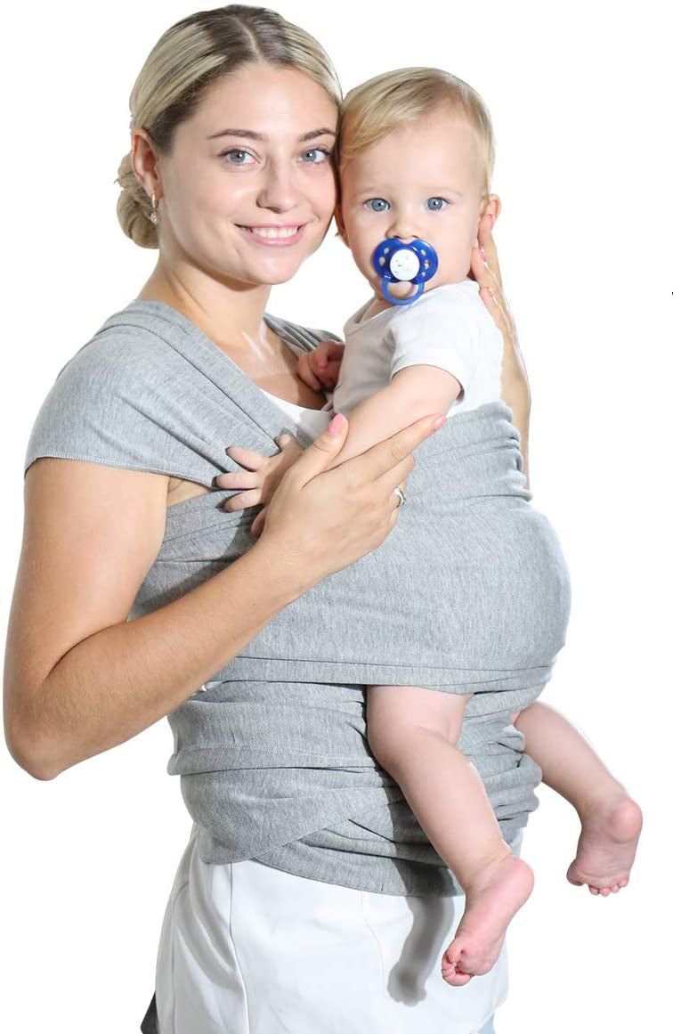 Woman holding a baby in a gray wrap carrier on a white background