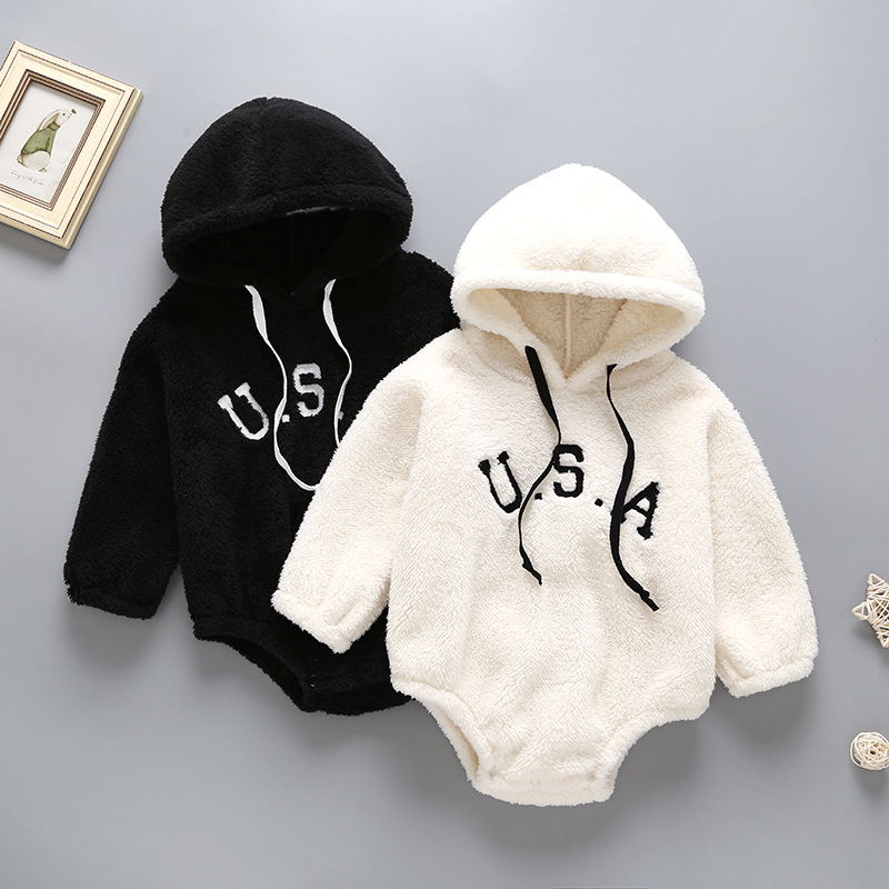 Black and white baby onesies with 'U.S.A' text on a gray background