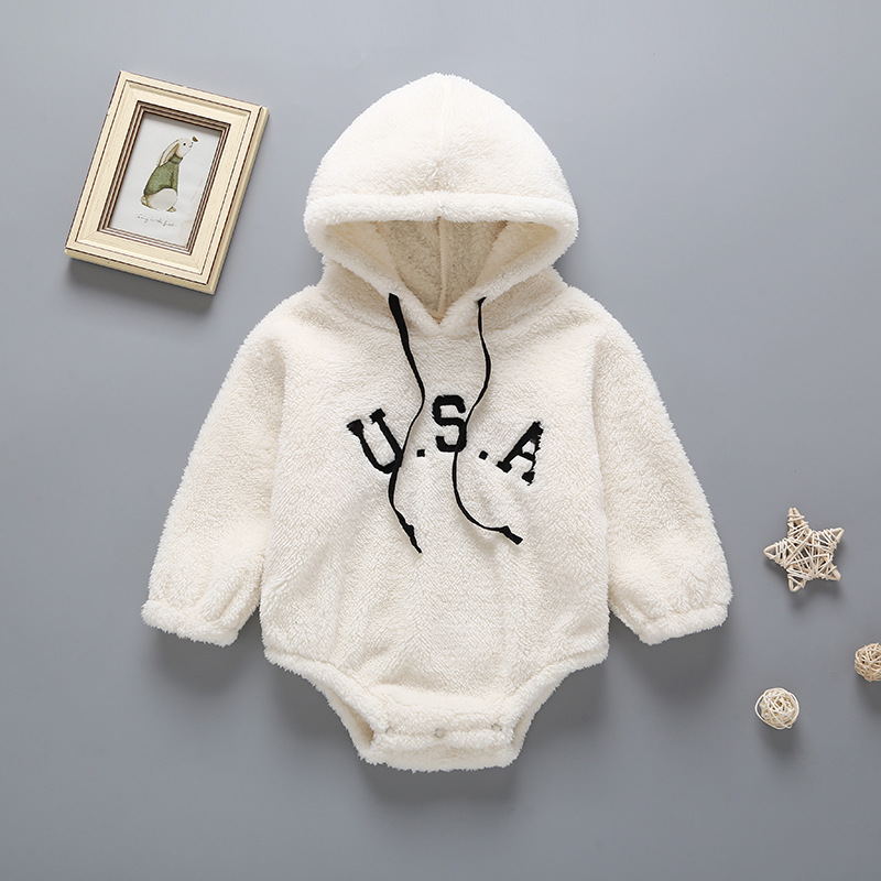 White fleece baby onesie with 'U.S.A.' text on a gray background