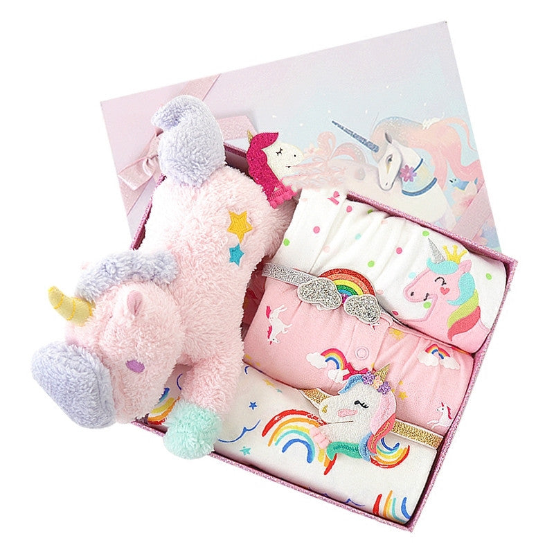 Pink unicorn-themed gift set with plush toy and stationery items in a decorative box.